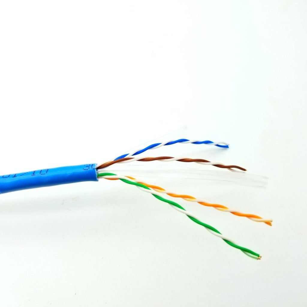 Stripped Cat6 LAN cable showing four twisted pairs, foil shield and drain wire